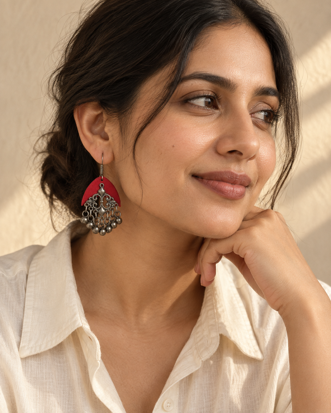 Editorial portrait of a woman wearing Arcis Aabha red fabric earrings